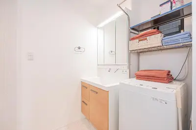 a white laundry room with a washer and dryer at Japan House Skytree \u30f4\u30a3\u30e9\u8cb8\u5207 B\u9928 in Tokyo