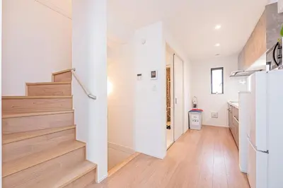 a hallway with white walls and stairs in a house at Japan House Skytree \u30f4\u30a3\u30e9\u8cb8\u5207 B\u9928 in Tokyo