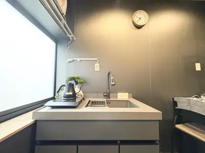 a kitchen with a sink and a clock on the wall at Ikebukuro\u6b63\u548c\u5eb5 in Tokyo