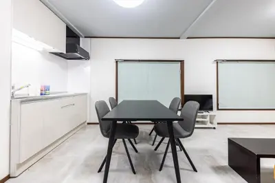 a kitchen and dining room with a table and chairs at M-stay Nishi-shinjuku in Tokyo
