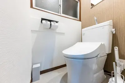 a bathroom with a white toilet and a window at M-stay Nishi-shinjuku in Tokyo