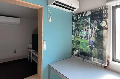 a mirror in a room with a painting on the wall at KIKA STAY - Tokyo 202 with Car park in Tokyo