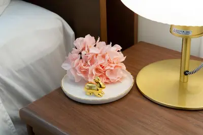 a table with a small figurine of a flower on it at \u90fd\u5fc3\u7f55\u89c1 \u79cb\u53f6\u539f\u4e1c\u4eac\u7ad9KBoa \u8d85\u7ea7\u5962\u534e\u53cc\u5367\u5957\u623f\u5e26\u53a8\u623f \u5730\u94c13\u5206\u949f \u6234\u68eePOLA\u9876\u7ea7\u914d\u7f6e \u79cb\u53f6\u539f\u6b65\u884c\u53ef\u8fbe \u4e1c\u4eac\u7ad94\u5206\u949f in Tokyo
