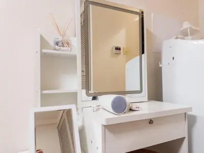 a mirror sitting on a white desk with a sink at Ichigaya Stay & Wi-Fi 1 in Tokyo
