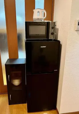 a microwave sitting on top of a computer tower at S,F, Heights - Vacation STAY 18516 in Tokyo