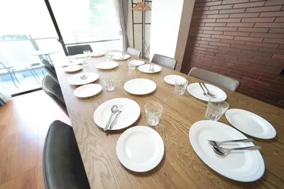 a long table with white plates and silverware on it at Contrail Room 203 - Vacation STAY 18527 in Tokyo