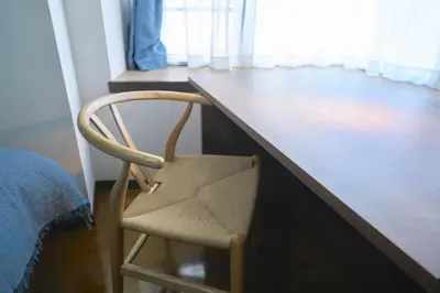 a wooden desk with a chair next to a bed at Contrail Room 203 - Vacation STAY 18527 in Tokyo