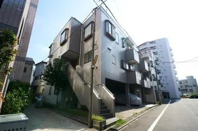 a building with a spiral staircase next to a street at Contrail Room 203 - Vacation STAY 18527 in Tokyo