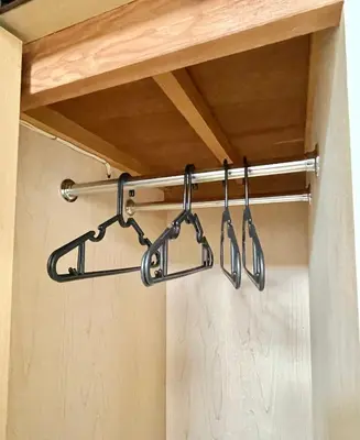a rack with four utensils hanging from a shelf at YMK Oshiage 4B in Tokyo