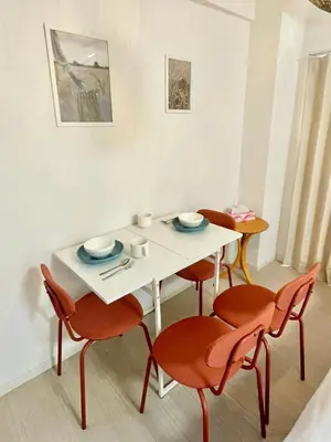 a white table with four chairs and a white table and chairsktop at YMK Oshiage 5B in Tokyo