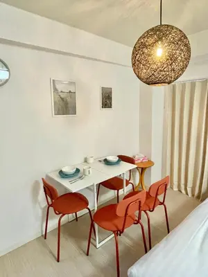 a room with a table and chairs and a bed at YMK Oshiage 5B in Tokyo