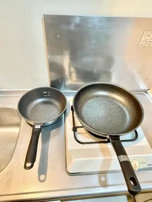 two frying pans sitting on top of a stove at YMK Oshiage 5B in Tokyo