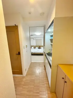 a hallway with a room with a bed in the background at YMK Oshiage 5B in Tokyo