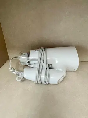 a white blow dryer sitting on the floor at YMK Oshiage 5B in Tokyo