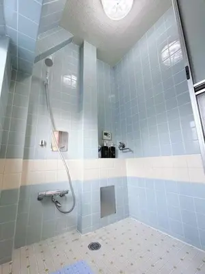 a bathroom with a shower with blue and white tiles at Ueno Sky Garden in Tokyo