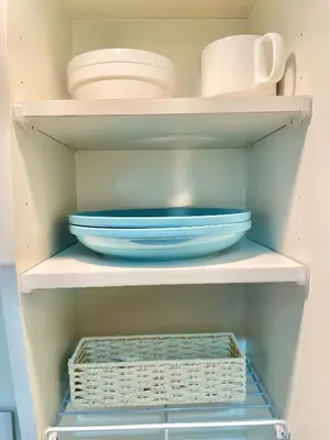 a shelf with plates and bowls in a refrigerator at YMK Oshiage 7A in Tokyo