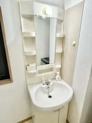 a bathroom with a white sink and a mirror at YMK Oshiage 7A in Tokyo
