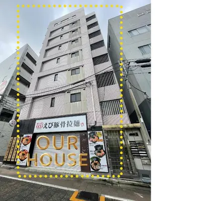 a tall building with a sign in front of it at YMK Oshiage 7A in Tokyo