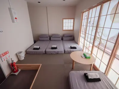 a room with two beds and a table in it at Live in Ginza 70 square meters, 2 bedrooms, 1kitchen 4toilet 2bath,room, project in Tokyo
