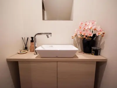 a bathroom with a sink and flowers on a counter at Live in Ginza 70 square meters, 2 bedrooms, 1kitchen 4toilet 2bath,room, project in Tokyo