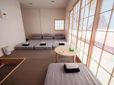 a room with two beds and a table and windows at Live in Ginza 70 square meters, 2 bedrooms, 1kitchen 4toilet 2bath,room, project in Tokyo