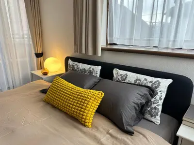 a bedroom with a bed with a yellow pillow on it at Mark\u7684\u5c0f\u5ca9\u6c11\u5bbf in Tokyo