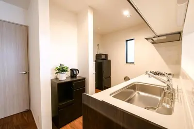 a kitchen with a sink and a refrigerator at AS\u685c\u4e0a\u6c34Villa in Tokyo