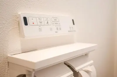 a white sink in a bathroom next to a wall at AS\u685c\u4e0a\u6c34Villa in Tokyo