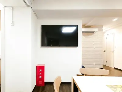 a living room with a flat screen tv on a wall at YayoiHotel in Tokyo