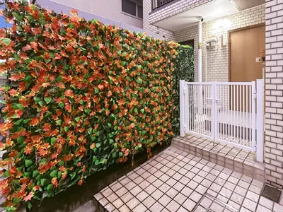 a fence with a bunch of flowers on it at YayoiHotel in Tokyo