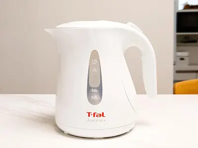 a white electric kettle sitting on a counter at YayoiHotel in Tokyo