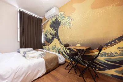 a hotel room with a bed and a table with towels at Ikebukuro-Mejiro Good Place House in Tokyo