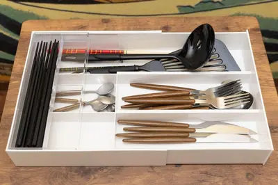 a white drawer filled with utensils on a table at Ikebukuro-Mejiro Good Place House in Tokyo