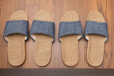 four pairs of socks on a wooden floor at Ikebukuro-Mejiro Good Place House in Tokyo