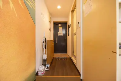 a hallway with two pairs of shoes on the floor at Ikebukuro-Mejiro Good Place House in Tokyo