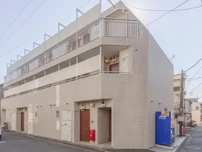 a brick building with a balcony on top of it at Ikebukuro-Mejiro Good Place House in Tokyo