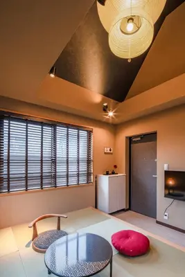 a room with a table and two chairs and a tv at LiveGRACE Hotel Asakusa \u6d45\u8349\u9685\u7530\u5ddd in Tokyo