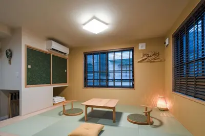 a classroom with a table and chairs and a chalkboard at LiveGRACE Hotel Asakusa \u6d45\u8349\u9685\u7530\u5ddd in Tokyo
