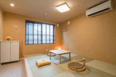 a living room with a table and a window at LiveGRACE Hotel Asakusa \u6d45\u8349\u9685\u7530\u5ddd in Tokyo