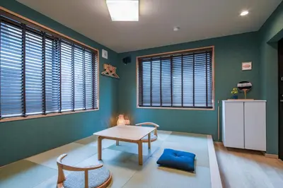 a room with a table and chairs and windows at LiveGRACE Hotel Asakusa \u6d45\u8349\u9685\u7530\u5ddd in Tokyo