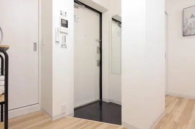 a hallway with white walls and a door at CH RESiDENCE \u4e21\u56fd in Tokyo