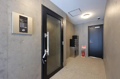 a hallway with a door leading to a elevator at CH RESiDENCE \u4e21\u56fd in Tokyo