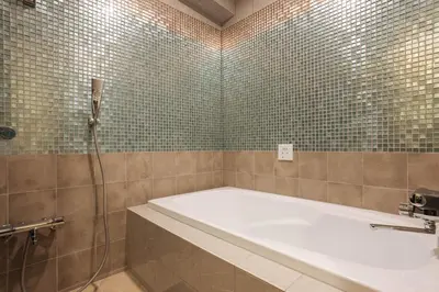 a bathroom with a bath tub and a shower at Hotel en \u30db\u30c6\u30eb \u30a8\u30f3-Adult Only- in Tokyo