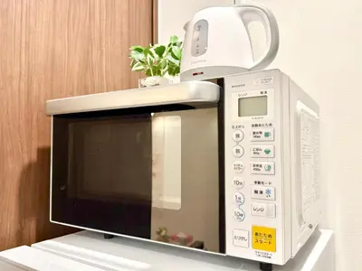 a microwave oven sitting on top of a table at Tokyo Life hotel in Tokyo