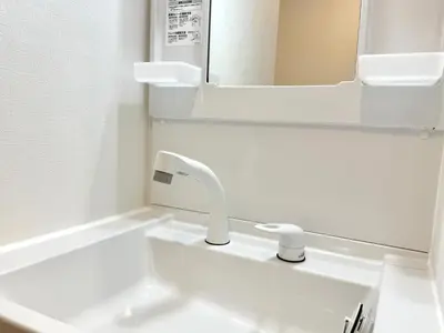 a bathroom with a white sink and a mirror at Tokyo Life hotel in Tokyo