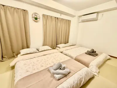 a bedroom with two beds and a window at Tokyo Life hotel in Tokyo