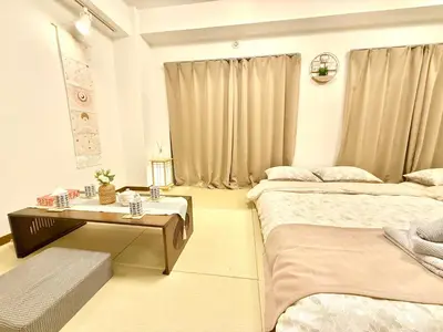 a hotel room with two beds and a table at Tokyo Life hotel in Tokyo