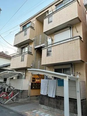 a building with towels hanging off the side of it at Japan House Ikebukuro Honcho in Tokyo