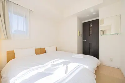 a bedroom with a large white bed with white sheets at SQ312-5 mins Shibuya Station JR Yamanote - Max 2 in Tokyo