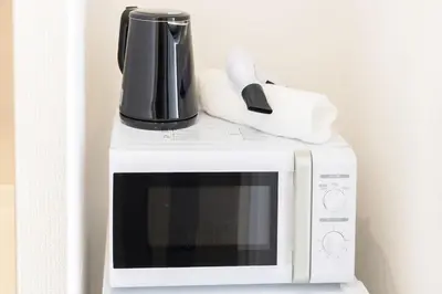 a coffee pot on top of a microwave at SQ312-5 mins Shibuya Station JR Yamanote - Max 2 in Tokyo
